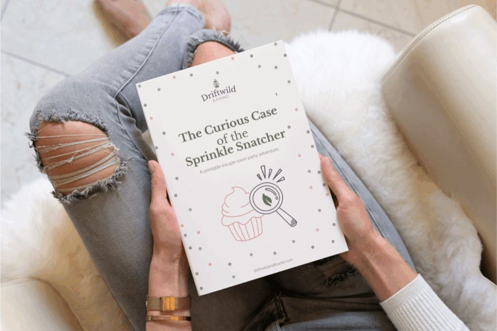 Woman holding a copy of The Curious Case of the Sprinkle Snatcher printable escape room book